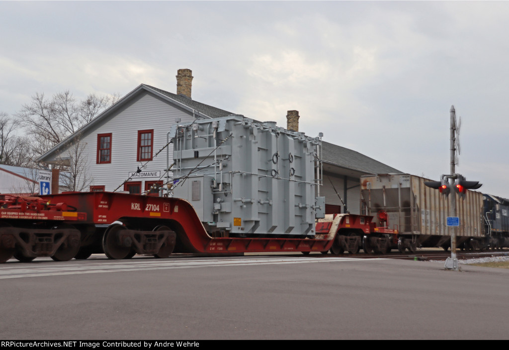 KRL 27104 carries the big transformer past the 1857 depot